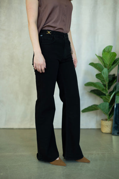 Black flare jeans with gold buckles