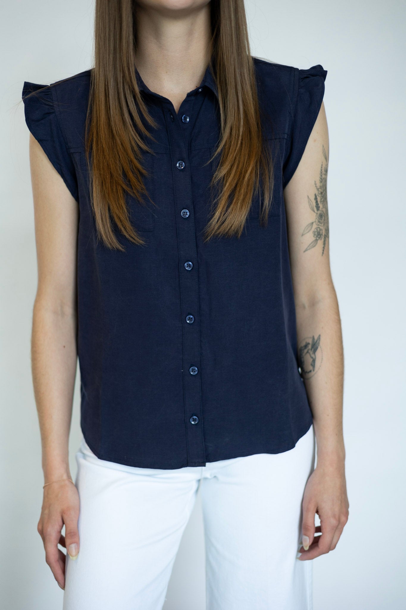 Women's sleeveless button down with ruffle details