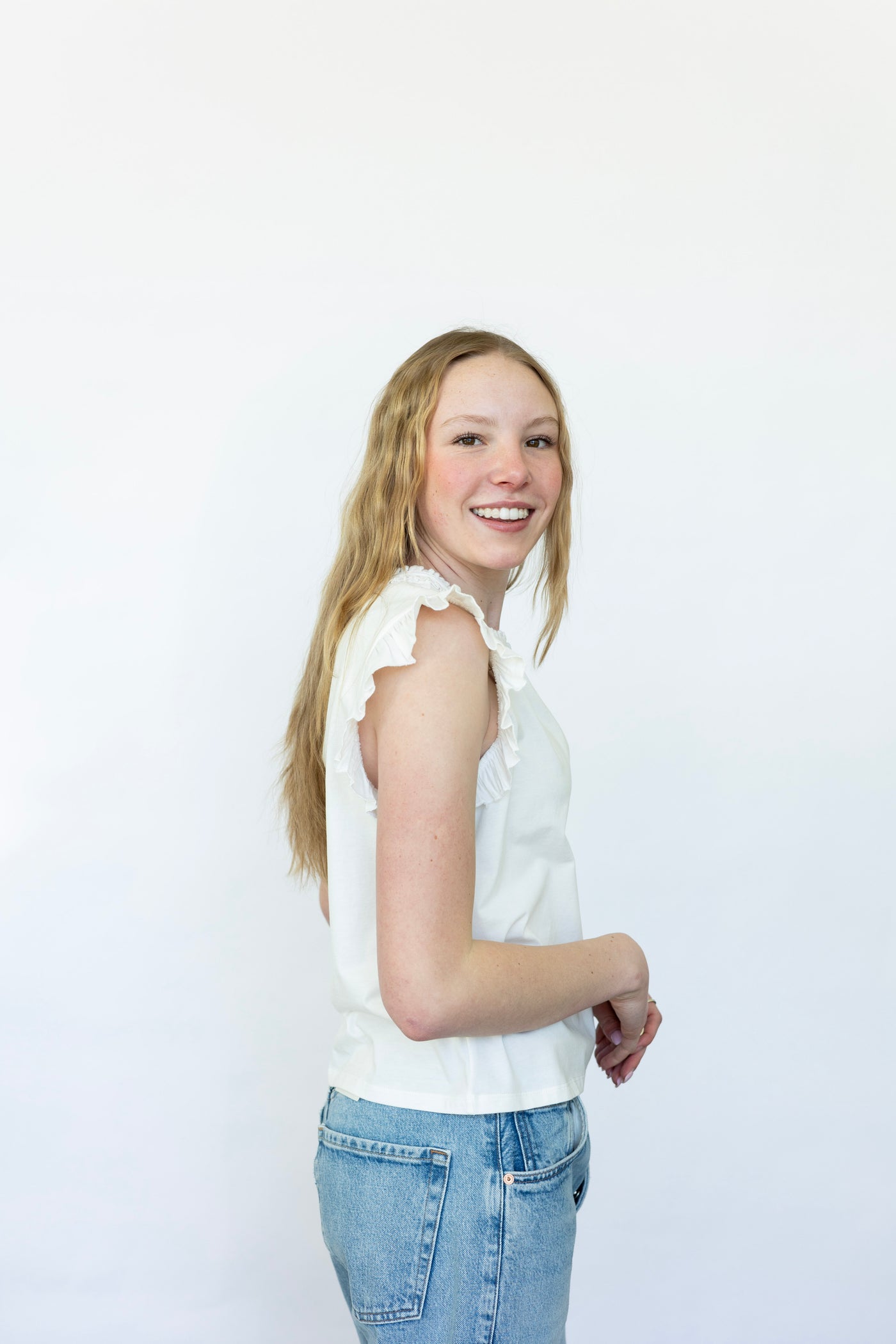 Sleeveless white blouse with ruffles