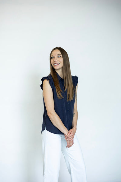 Women's sleeveless button down with ruffle details
