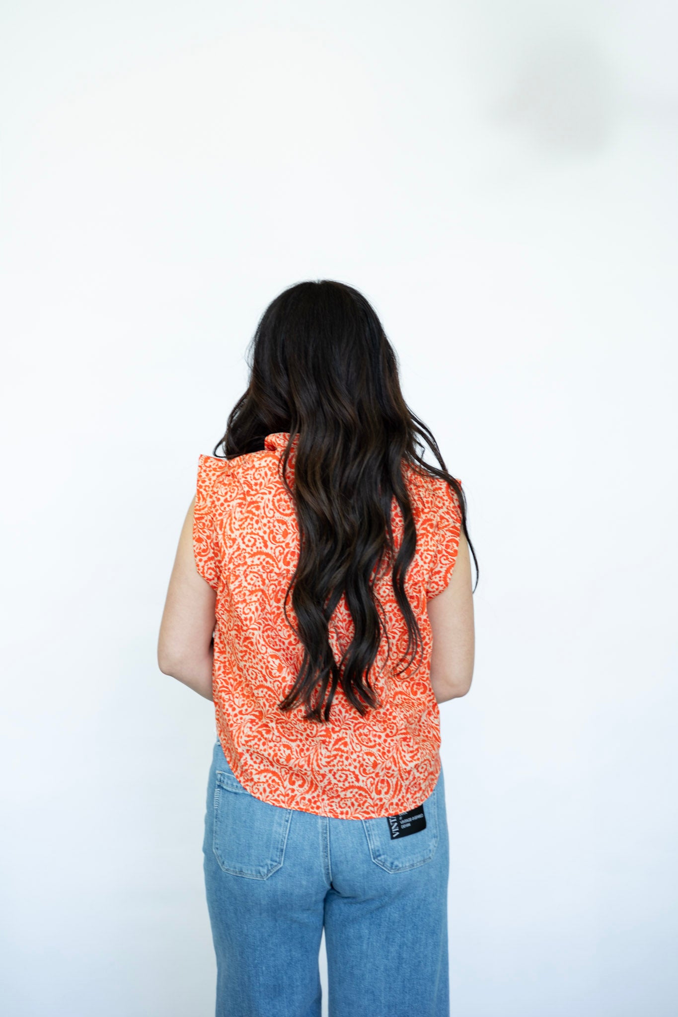 Floral print orange sleeveless blouse