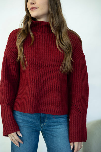 Red turtleneck sweater with wide sleeves
