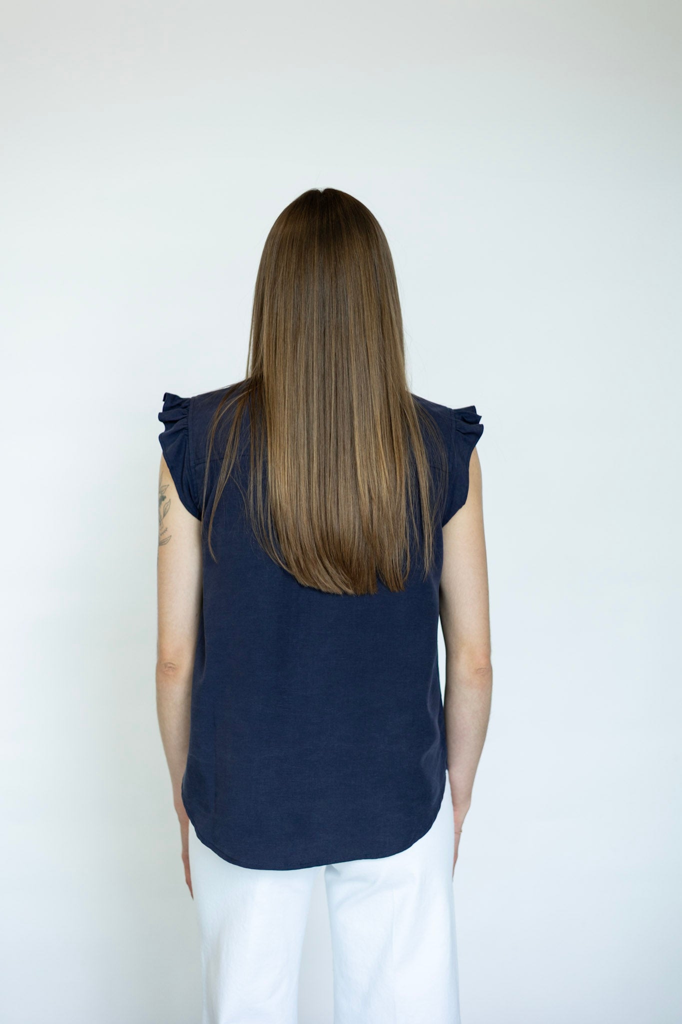 Women's sleeveless button down with ruffle details