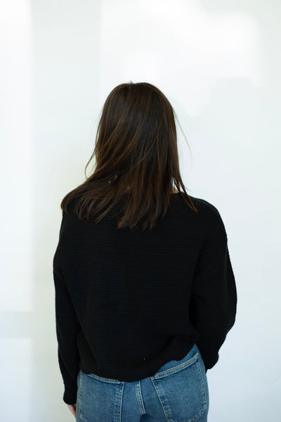 Black sweater with buttons on shoulder