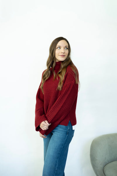 Red turtleneck sweater with wide sleeves
